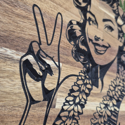 Close up shot showing CNC Carved plaque saying Aloha, Beaches! with a 50's Pinup showing a Peace sign