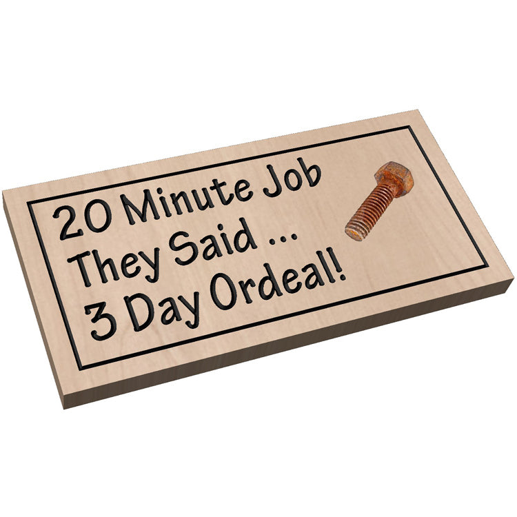 Angled shot of a Handcrafted relief-carved hardwood sign featuring the text "20 Minute Job They Said... 3 Day Ordeal!" and a unique, reclaimed rusty bolt or part.