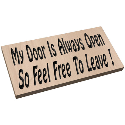 Angled view of a relief carved hardwood sign featuring the text: My Door Is Always Open So Feel Free To Leave!
