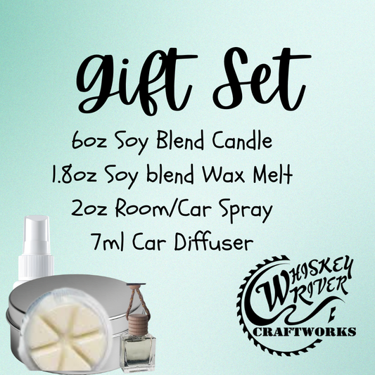 The Ultimate Fragrance Gift Set by Whiskey River Craftworks, featuring a 6oz soy-blend candle, 1.8oz soy wax melt, 2oz room/car spray, and a 7ml car diffuser, all presented on a light blue background.