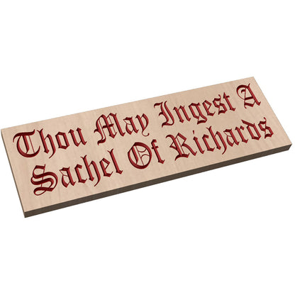 Angled shot of a custom hardwood sign with relief carved red Gothic script text Thou May Ingest A Sachel Of Richards.