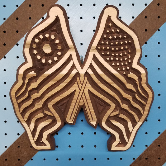 Handcrafted relief-carved hardwood sign in the shape of crossed American flags.