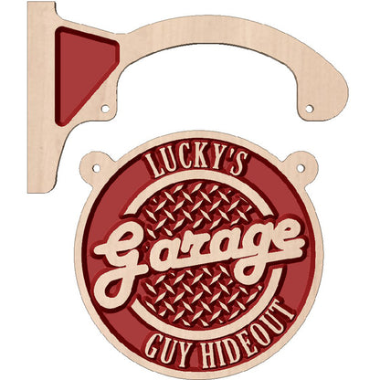 Personalized wooden hanging circle sign displayed as custom wall decor outside a garage or workshop.