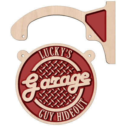 Personalized double-sided wooden hanging circle sign displayed as custom wall decor outside a garage or workshop.