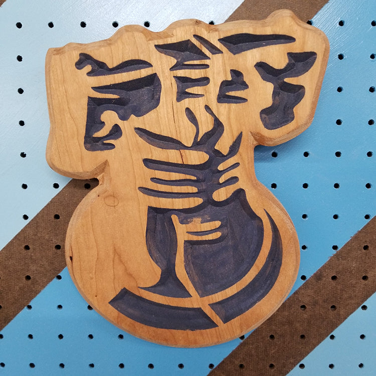 Relief carved hardwood sign in the shape of the historic Liberty Bell, featuring a detailed yoke and clapper design with blue paint.