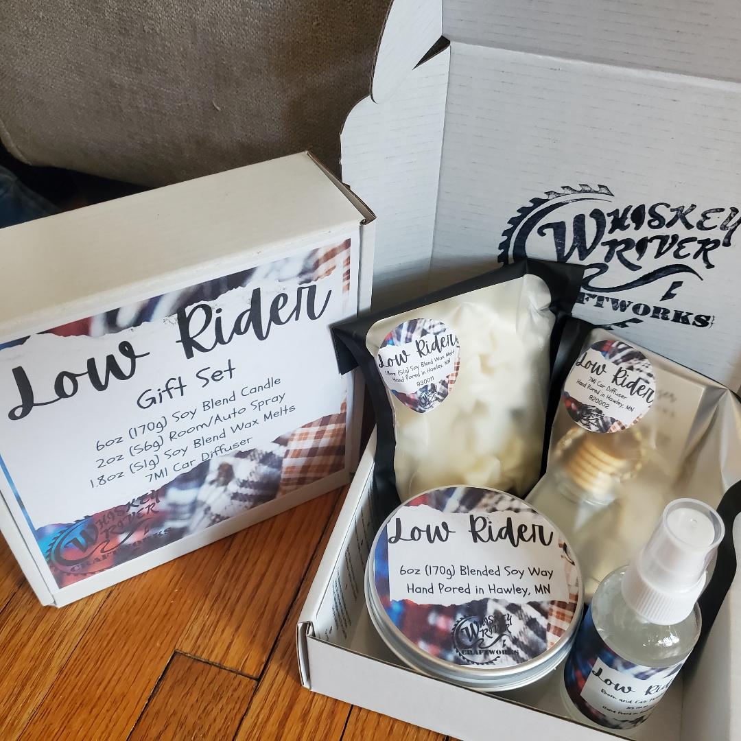 Handcrafted "Low Rider" fragrance gift set, featuring a 6oz soy-blend candle, 1.8oz soy wax melt, 2oz spray, and 7ml car diffuser, offering a smooth, classic scent profile.