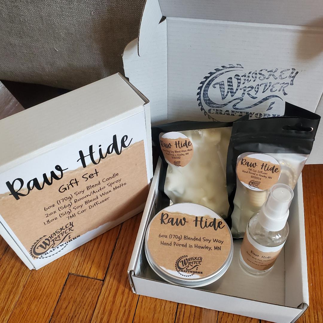 Handcrafted "Raw Hide" fragrance gift set, featuring a 6oz soy-blend candle, 1.8oz soy wax melt, 2oz spray, and 7ml car diffuser with a rich, rugged leather-inspired scent.