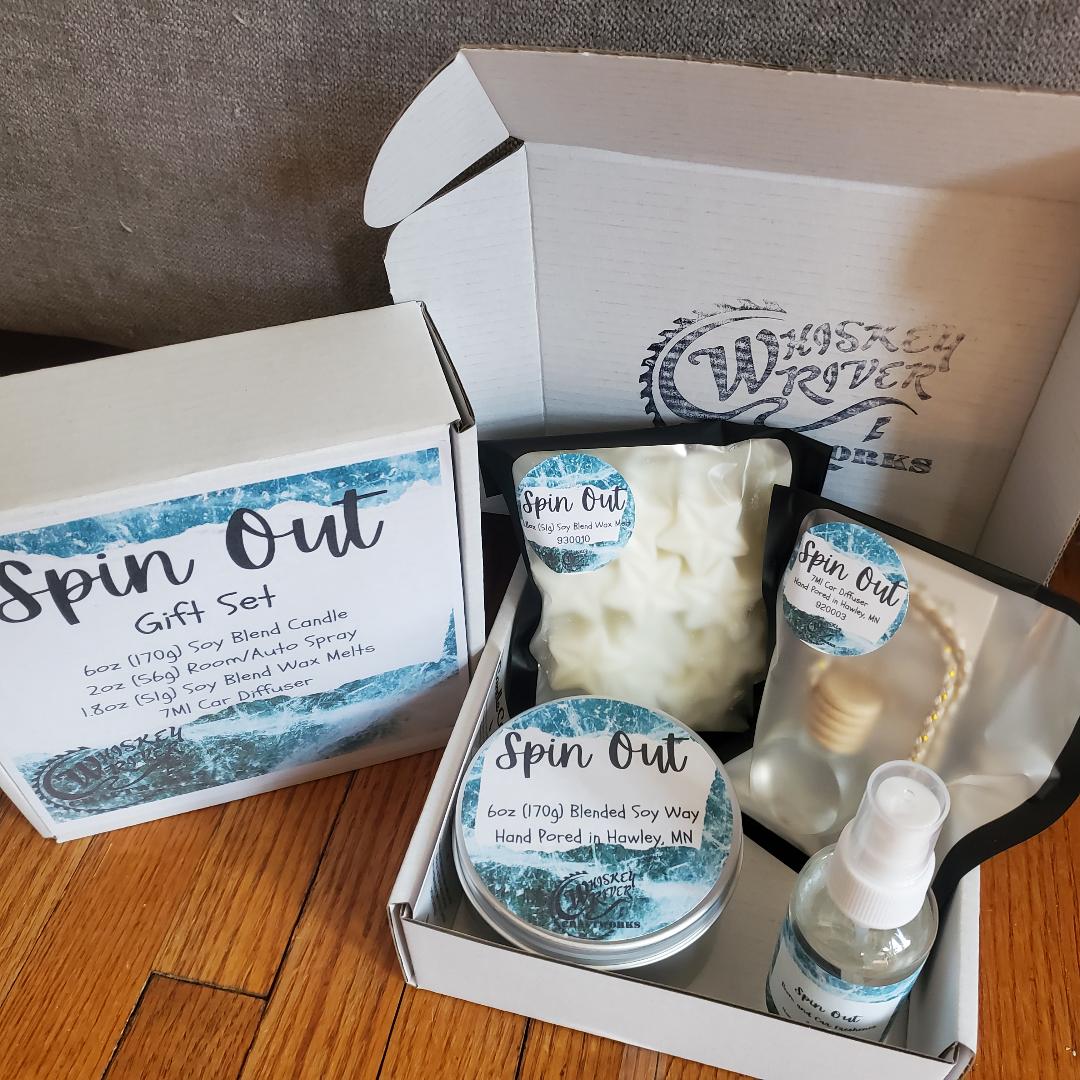 Handcrafted "Spin Out" fragrance gift set, featuring a 6oz soy-blend candle, 1.8oz soy wax melt, 2oz spray, and 7ml car diffuser, capturing a fast-paced, high-octane scent.