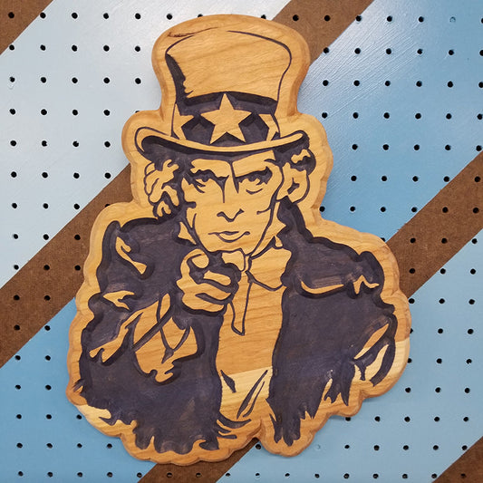 Custom hardwood Uncle Sam patriotic garage sign with carved Americana relief design on a blue pegboard.